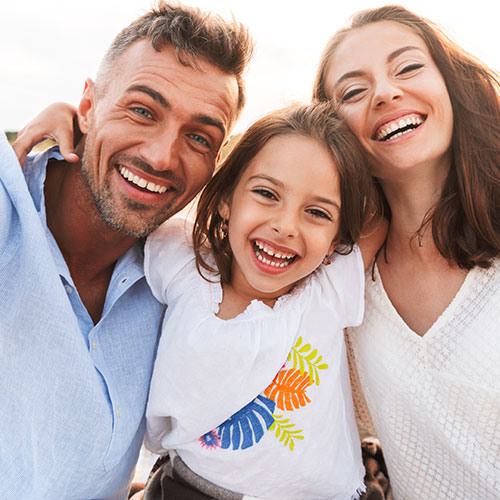 family laughing outdoors